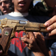 Illustration for article titled Qaddafi Died Packing a Giant Golden Gun